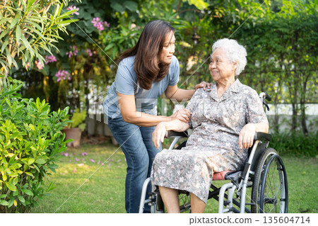 Asian elderly woman disability patient sitting on wheelchair in park. Asian elderly woman disability patient sitting on wheelchair in park. 135604714