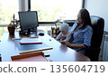 Working mother, balancing business and baby at the office desk 135604719