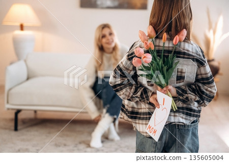 I love mom text on gift card, with flowers. Mother and daughter are together in domestic room I love mom text on gift card, with flowers. Mother and daughter are together in domestic room 135605004