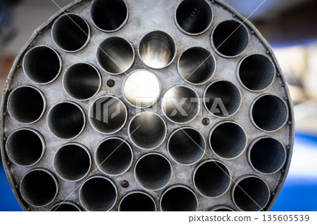 Military aircraft rocket launcher showing empty tubes pattern Military aircraft rocket launcher showing empty tubes pattern 135605539