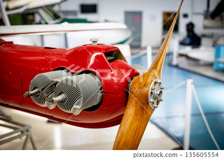 Vintage airplane engine with wooden propeller in museum Vintage airplane engine with wooden propeller in museum 135605554
