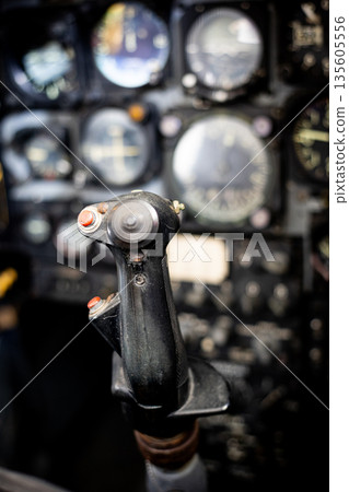 Vintage aircraft cockpit controlling flight instruments 135605556