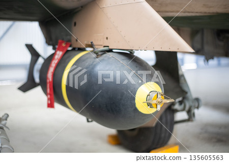 Military aircraft carrying bomb for war mission 135605563