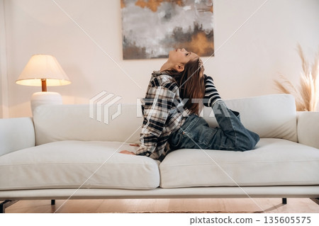 Fun on the sofa. Cute little girl is in the domestic room alone 135605575