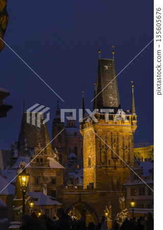 Lesser Town Bridge Tower and old city architecture in snowy Prague 135605676
