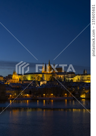 Prague Castle and Old Town city skyline glowing at night over Vltava River, Czechia Prague Castle and Old Town city skyline glowing at night over Vltava River, Czechia 135605681