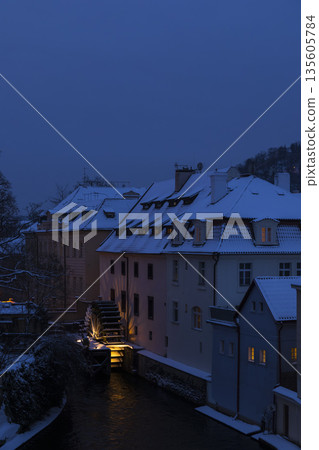 Prague water mill glowing at twilight in winter Prague water mill glowing at twilight in winter 135605784