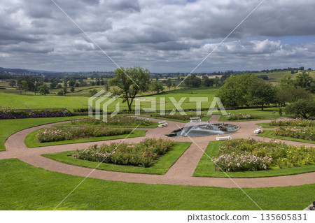 Formal garden landscaping featuring circular rose beds and fountain in Curbigny, France Formal garden landscaping featuring circular rose beds and fountain in Curbigny, France 135605831