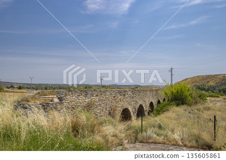 Roman bridge arches crossing dry riverbed in Alcanadre 135605861