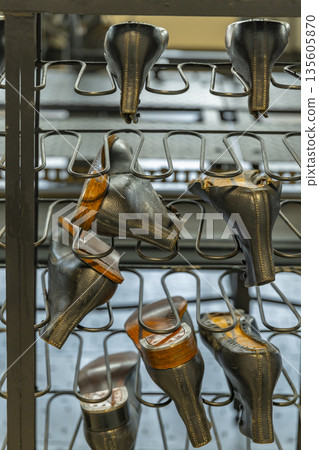 Shoe uppers drying on a metal rack in Zlin factory Shoe uppers drying on a metal rack in Zlin factory 135605870