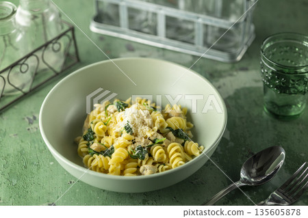 Fusilli pasta with chicken spinach and parmesan cheese Fusilli pasta with chicken spinach and parmesan cheese 135605878