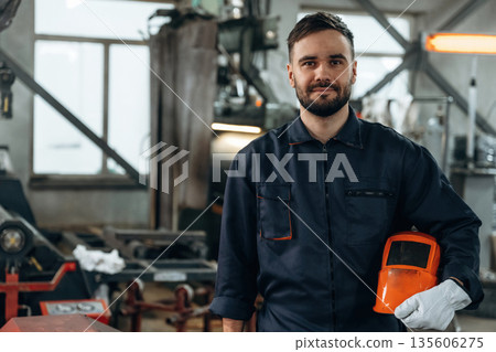 Front view, standing and posing. Man is working in the factory Front view, standing and posing. Man is working in the factory 135606275