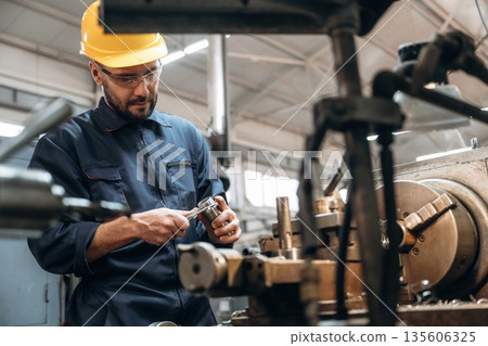 Metal job, by machine. Man is working in the factory 135606325
