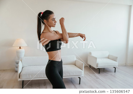 Hands warm up. Young woman with slim body type is indoors 135606547
