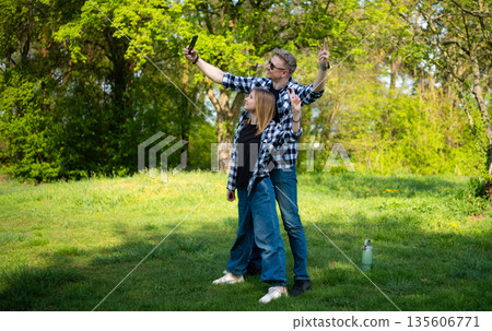 Happy Father And Daughter Taking A Selfie Showing A Victory Sign 135606771