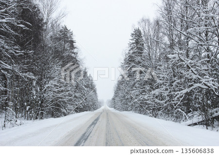 Winter road through the forest 135606838