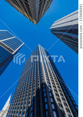 Office building in business district. Skyscraper building architecture. Business skyscraper. Modern glass building. Skyscraper in city downtown. City downtown with skyscraper. Tall tower 135606891