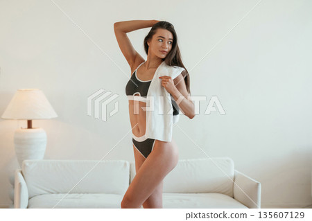 Young woman with slim body type is indoors Young woman with slim body type is indoors 135607129