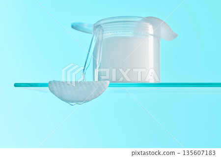 Skincare product jar and cotton pad on glass shelf Skincare product jar and cotton pad on glass shelf 135607183