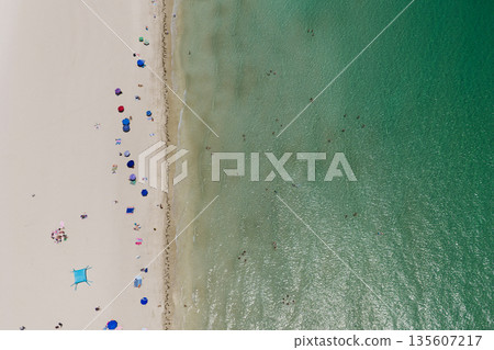 Paradise luxury resort. Summer vacation. Beach vacation at sea in summer. Sea relax under beach umbrella. Travel to sea. Aerial top view sand beach with crystal clear turquoise water. Luxury resort 135607217