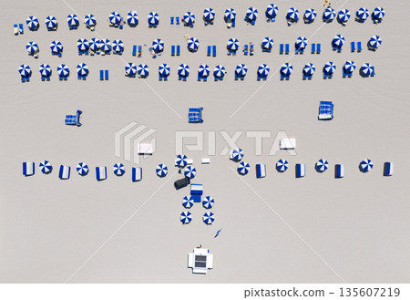 Summer vacation. Beach vacation at sea in summer. Sea relax under beach umbrella. Travel to sea. Aerial top view of sand beach with turquoise water. Luxury resort. Paradise beach. Beachside living 135607219