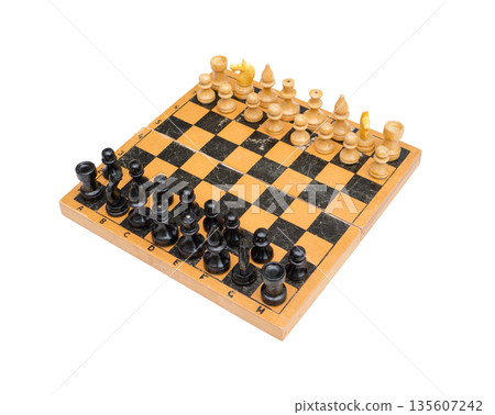 Vintage chess set with chessboard on white background. 135607242