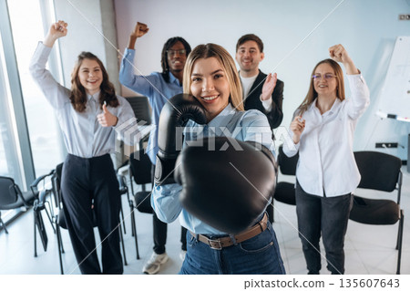 Sport of boxing. Group of young business people are in conference room Sport of boxing. Group of young business people are in conference room 135607643