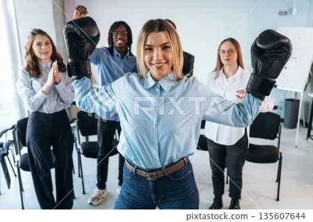 Sport of boxing. Group of young business people are in conference room 135607644
