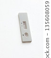 Pregnancy test kit showing negative result with one line visible on the test strip against a white background for health-related content 135608059
