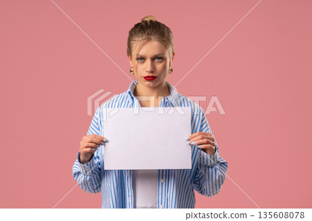Young Serious Caucasian blonde Woman With Blank Billboard In Hands. Copy space, Mockup Young Serious Caucasian blonde Woman With Blank Billboard In Hands. Copy space, Mockup 135608078