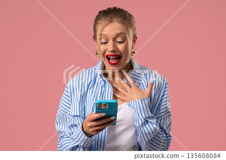 Surprised Shocked Woman With Smartphone. Happy Girl, Pink Studio Background, Joy Surprised Shocked Woman With Smartphone. Happy Girl, Pink Studio Background, Joy 135608084
