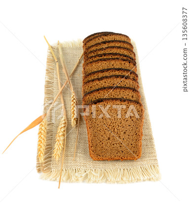 Sliced Rye Bread on Burlap Napkin with Wheat Ears 135608377