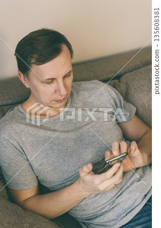 Serious man using smartphone 135608381