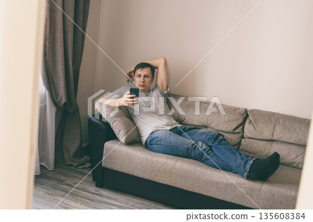 Serious man using smartphone 135608384