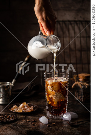 Ice coffee in a tall glass 135608386