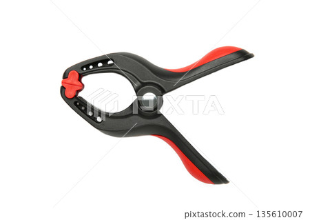 Plastic spring clamp isolated on white background. Plastic spring clamp isolated on white background. 135610007