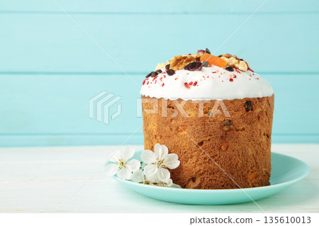Traditional easter cakes with colorful sprinkles, with eggs on blue background. Traditional easter cakes with colorful sprinkles, with eggs on blue background. 135610013