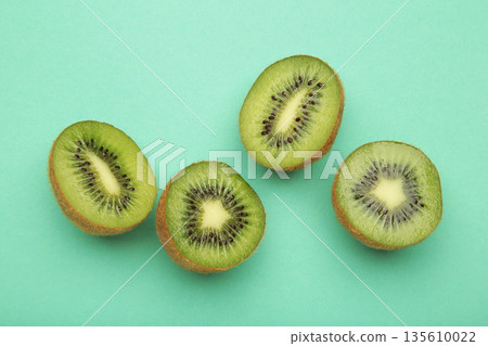 Green kiwi on mint background. Tropical fruit. Green kiwi on mint background. Tropical fruit. 135610022