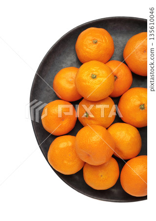 Fresh small tangerine mandarin orange in plate isolated on white background. Fresh small tangerine mandarin orange in plate isolated on white background. 135610046