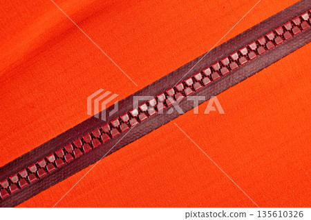 Close up of color zip on sport jacket , macro shot Close up of color zip on sport jacket , macro shot 135610326