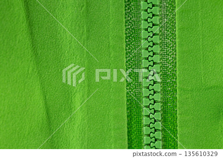 Close up of color zip on sport jacket , macro shot Close up of color zip on sport jacket , macro shot 135610329