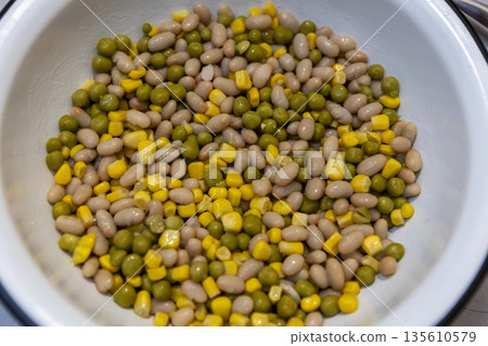 Mixed peas, beans, and corn in a bowl, top view, healthy food background 135610579