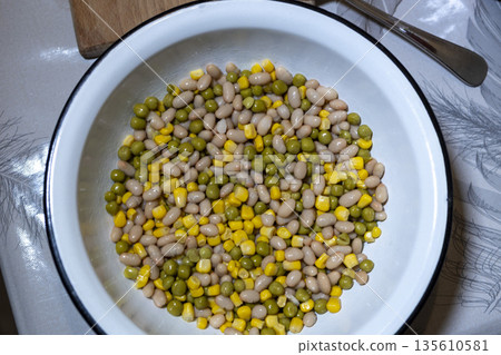 Peas, beans, and corn arranged in a bowl, healthy salad preparation 135610581