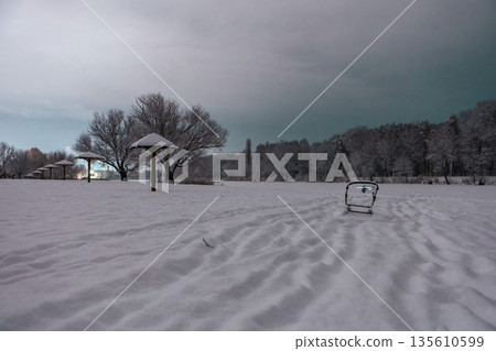 Umbrella-shaped canopies on a snowy winter night beach Umbrella-shaped canopies on a snowy winter night beach 135610599