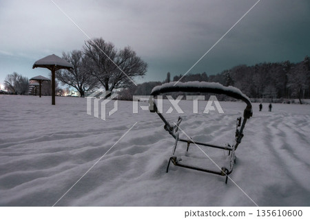snowy winter night beach with Umbrella-shaped canopies and metal frame of the stroller snowy winter night beach with Umbrella-shaped canopies and metal frame of the stroller 135610600