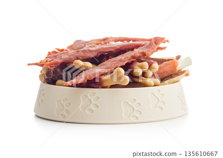 Dog food. Snack dried meat for dogs isolated on white background. Dog food. Snack dried meat for dogs isolated on white background. 135610667