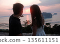 Romantic Couple Watching Sunset Over Tropical Sea and Islands 135611151