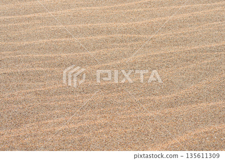 Fine beach sand texture with natural wavy patterns formed by wind on the Baltic Sea coastline Fine beach sand texture with natural wavy patterns formed by wind on the Baltic Sea coastline 135611309