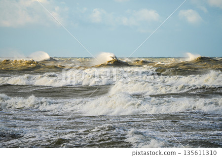 Powerful Baltic Sea storm waves crashing under cloudy sky, dynamic seascape with high surf and sea spray Powerful Baltic Sea storm waves crashing under cloudy sky, dynamic seascape with high surf and sea spray 135611310