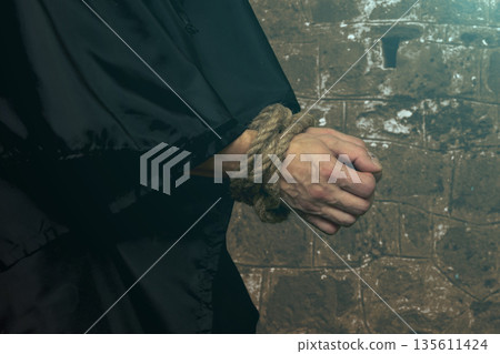 Bound monk hands without rosary on dark background 135611424